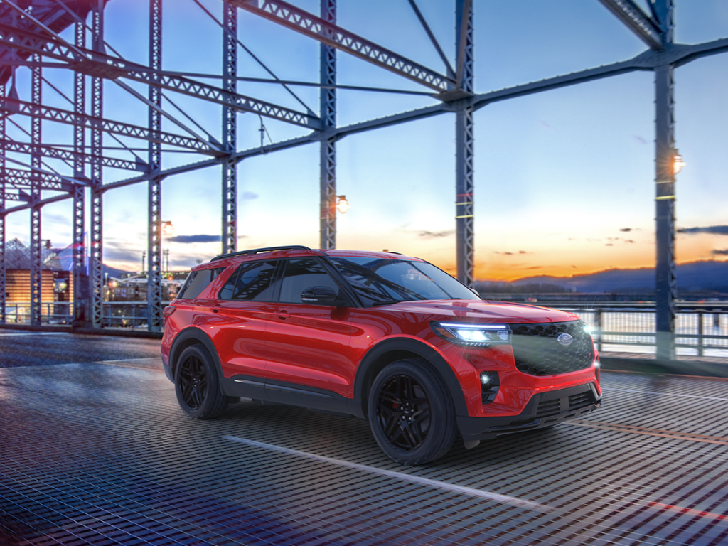 The new Ford Explorer drives across a bridge, showcasing its style and prowess. Shop for your new Ford Explorer at Johnson City Ford today.