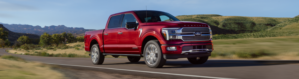 A new red Ford F-150 driving on the open road, making the F-150 truck a perfect choice for your holiday travel plans this year! Shop for your new Ford F-150 truck at Johnson City Ford!