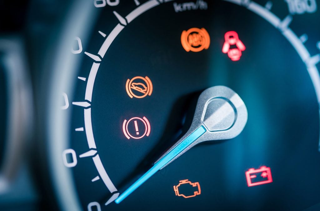 Many different car dashboard lights with warning lamps illuminated.