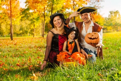 family in Halloween costume outside