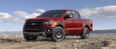 Hot Pepper color 2019 Ford Ranger exterior front fascia and drivers side parked in wilderness