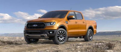 Saber color 2019 Ford Ranger exterior front fascia and drivers side parked in wilderness