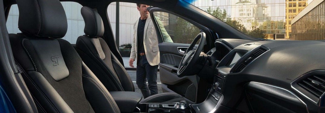 2019 Ford Edge interior side view of front cabin with man opening drivers side door