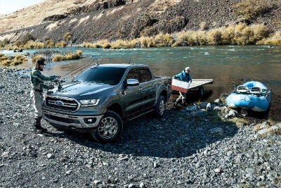 2019 Ford Ranger exterior front fascia and drivers side backed into water with two men and kayak