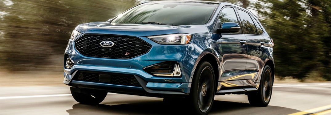 2019 ford edge st in blue driving at three quarter view