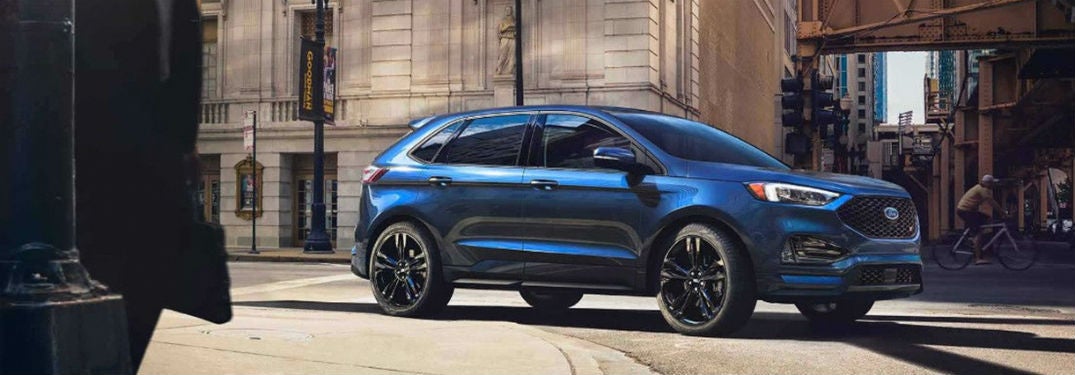 profile of 2019 ford edge st in blue parked on city street