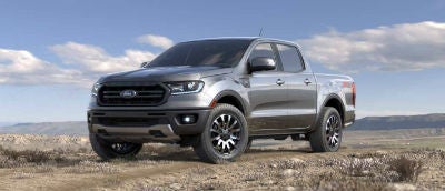 Ingot Silver color 2019 Ford Ranger exterior front fascia and drivers side parked in wilderness