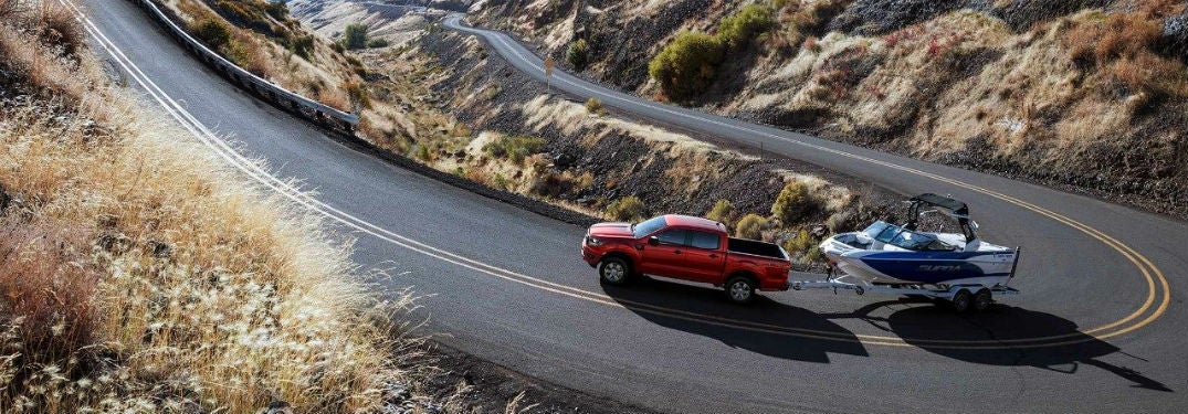 2019 Ford Ranger exterior driver side profile towing boat on road