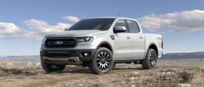 White Platinum color 2019 Ford Ranger exterior front fascia and drivers side parked in wilderness