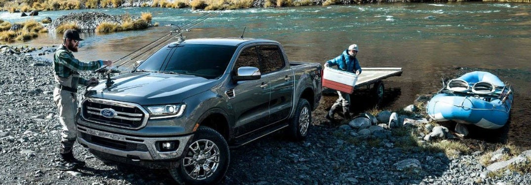 2019 Ford Ranger exterior front fascia and drivers side with two men unloading items into water