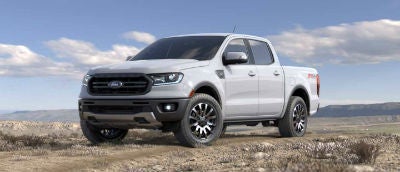 Oxford White color 2019 Ford Ranger exterior front fascia and drivers side parked in wilderness