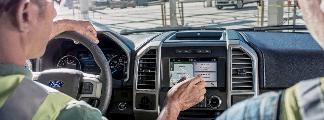 two-construction-workers-using-Ford-SYNC-3-with-phone-connection-in-Ford-vehicle