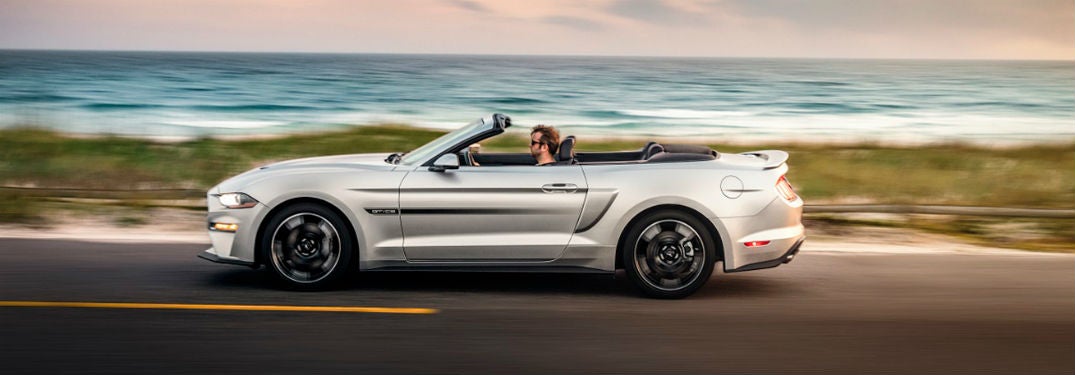 2019 Ford Mustang exterior drivers side profile man driving going fast on beach road
