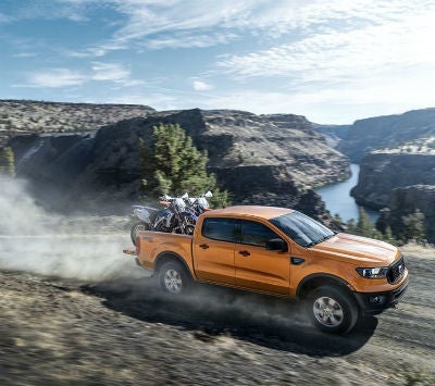2019 Ford Ranger exterior front fascia and passenger side going fast on dirt road