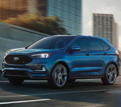 2019 Ford Edge exterior front fascia and drivers side going fast on city highway