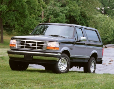 1995 Ford Bronco exterior front fascia and drivers side parked in grass by lake