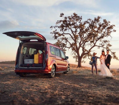 2019 Ford Transit Connect exterior back fascia with trunk open and people to right