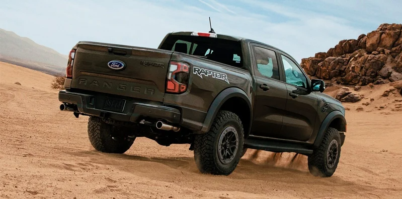 A Ford Ranger off-roading across some sandy dunes.