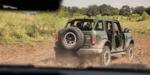 A 2024 Ford Bronco driving on a offroad terrain. 