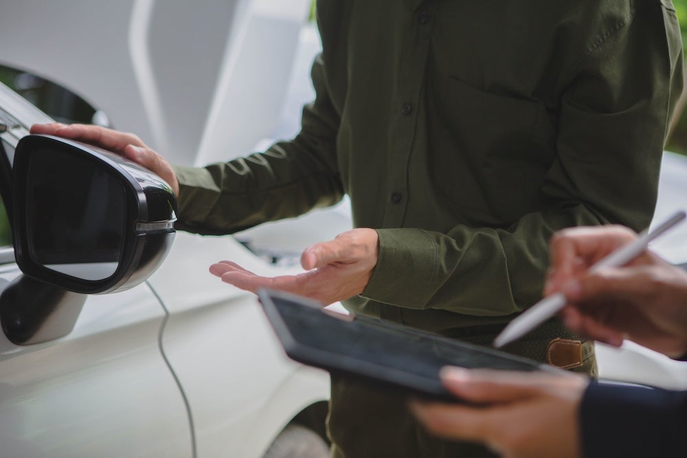 men examining car