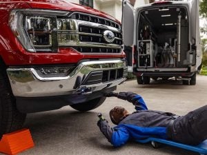A Ford mobile service taking place at someone's home.
