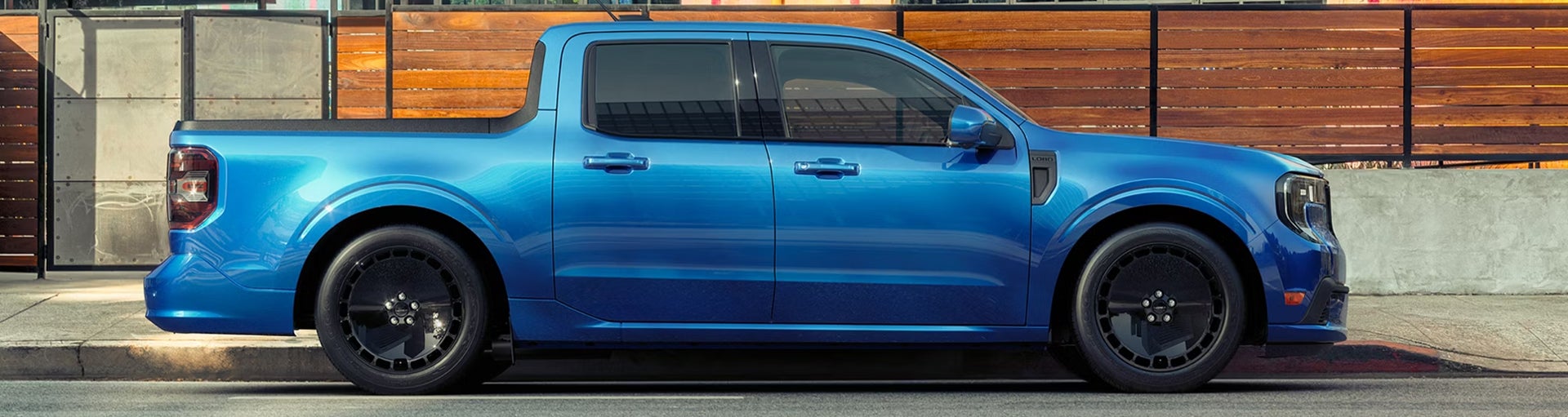 The side profile of a blue Ford Maverick Hybrid pickup truck