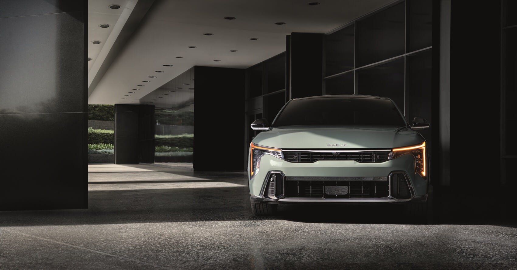 Technician servicing a Kia with maintenance plan coverage