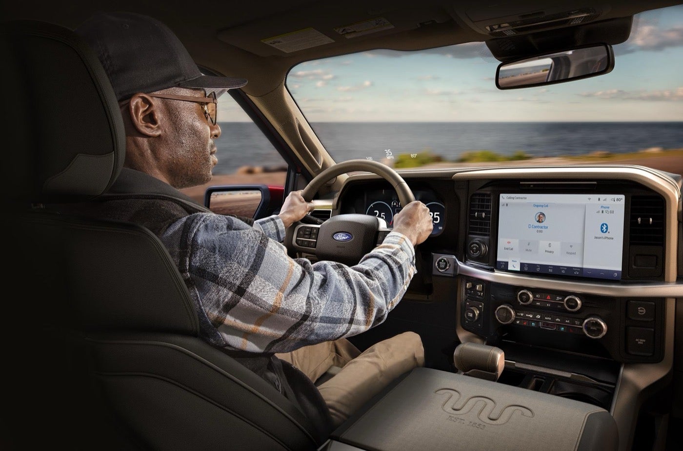 Man driving a Ford F-150 with the center display visible