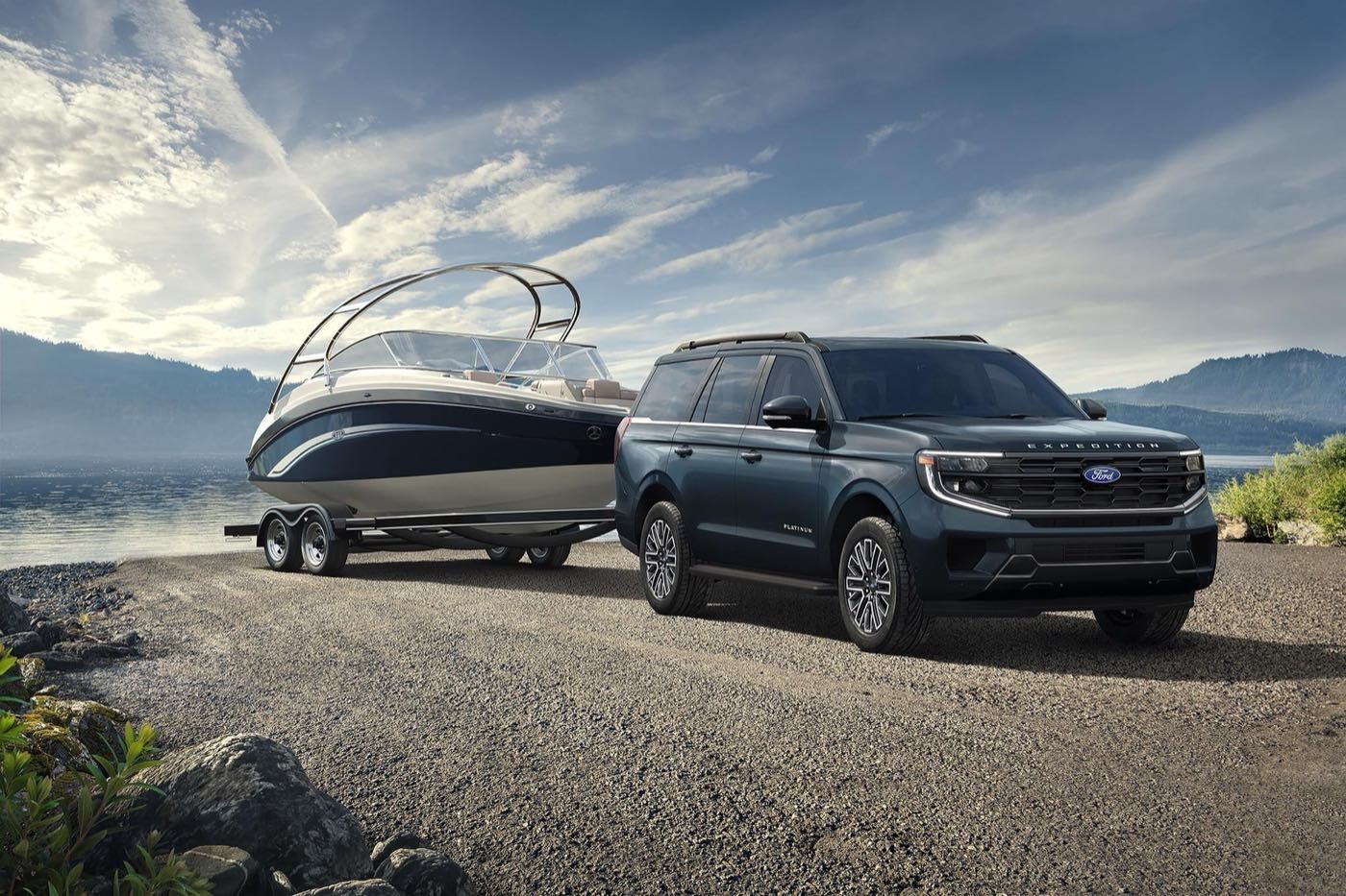 Ford Expedition Platinum with a driver towing a boat on a trailer