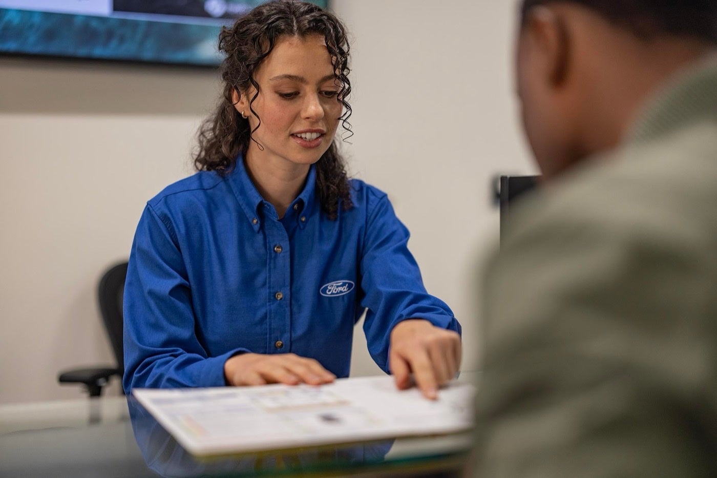 Ford Service representative reviewing needed service with a customer