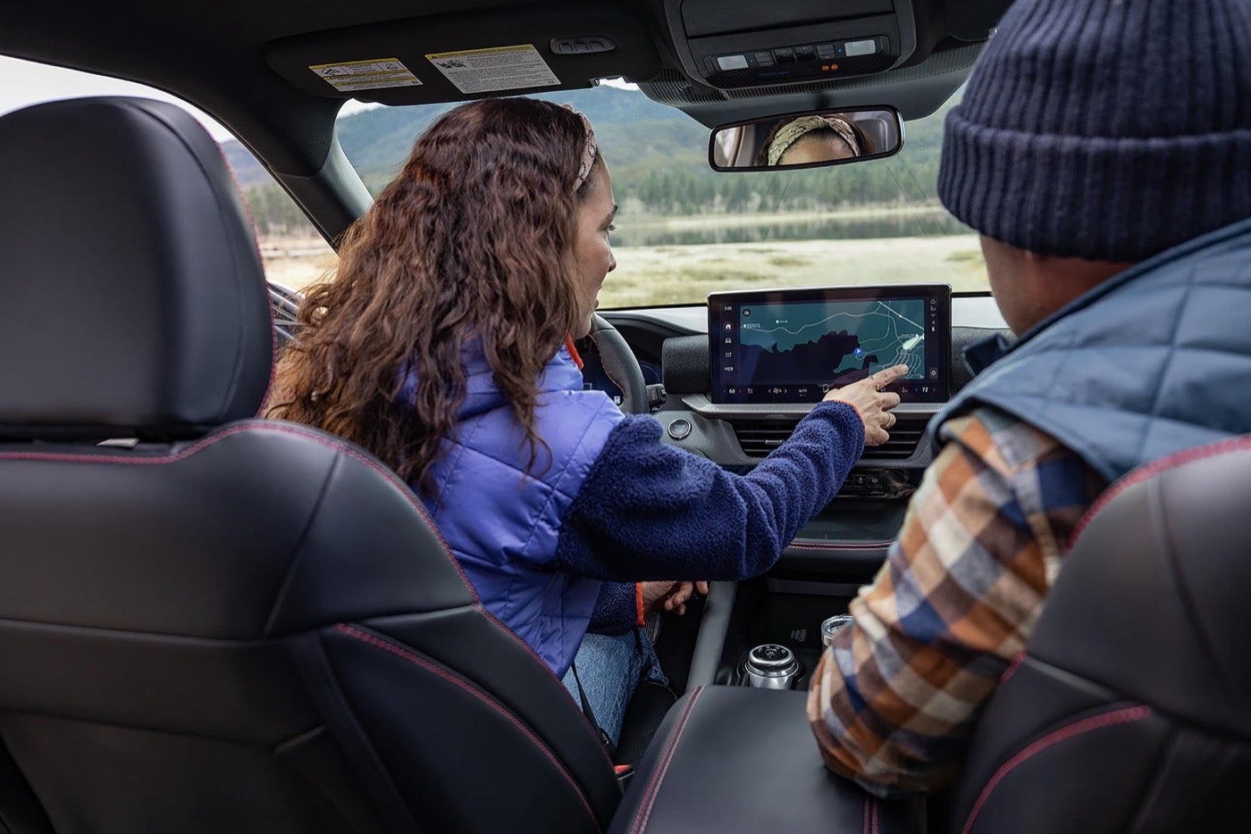 Driver using the center display touchscreen in a Ford Explorer