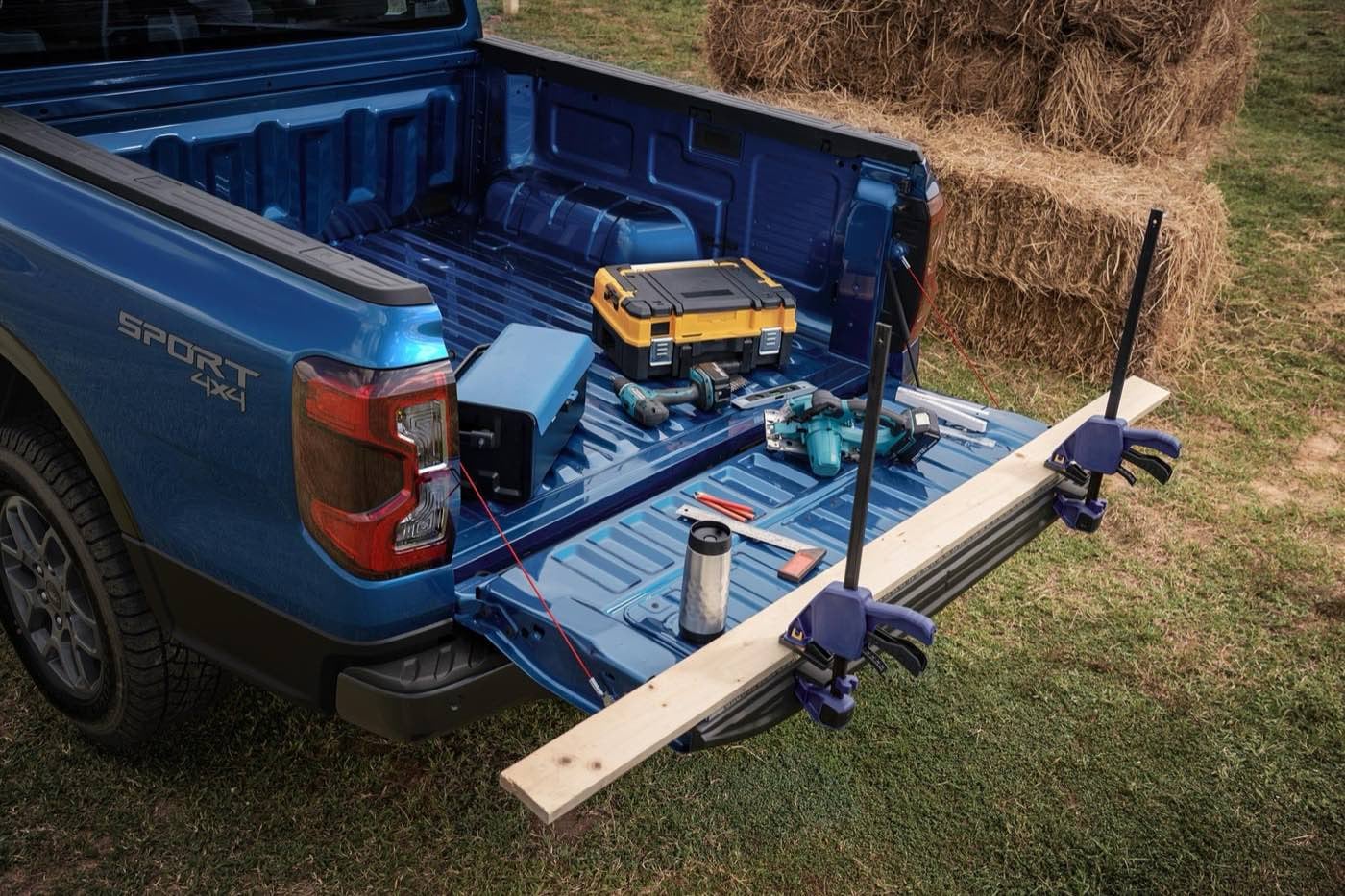 Ford Ranger with the tailgate open and tools in the bed