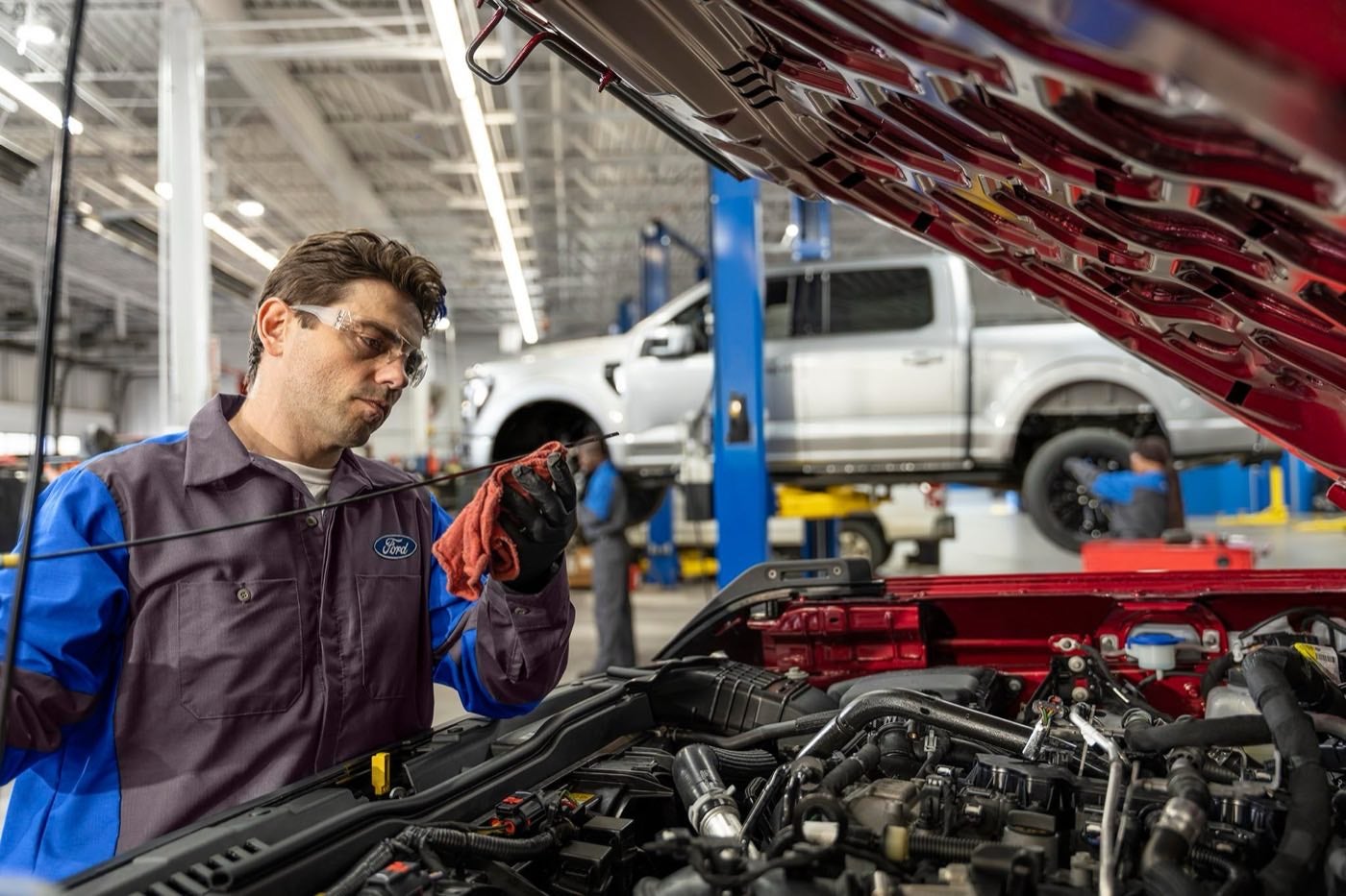 Ford Service technician working under the hood of a vehicle