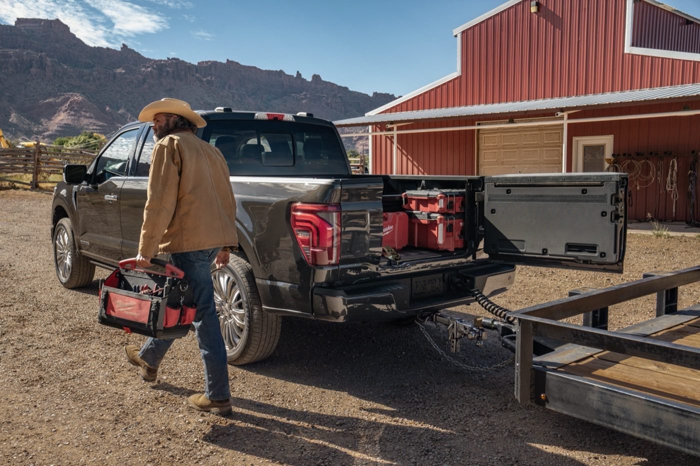 Man walking near a Ford F-150 Platinum with the Pro Access Tailgate open