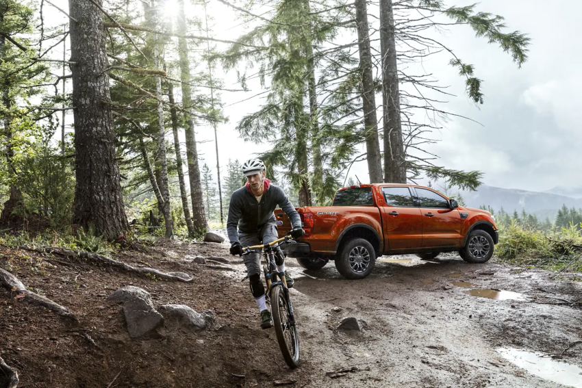 Orange Ford Ranger and male biker