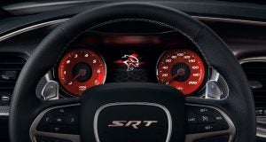 image of a black steering wheel with red speed details