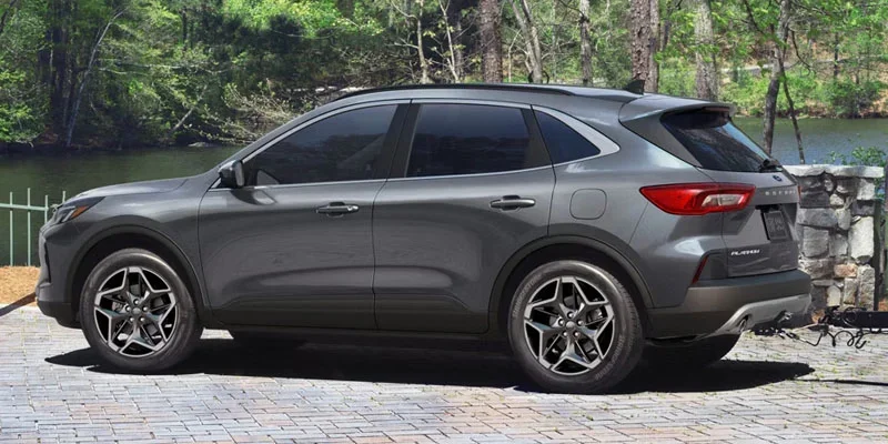 Gray Ford Escape SUV parked beside a lakeside setting.