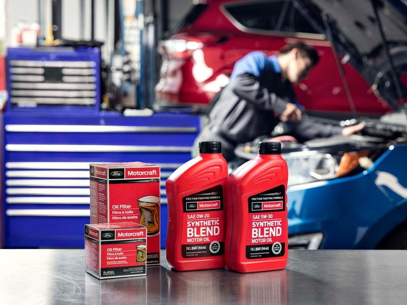 Oil filters and synthetic blend motor oil bottles on a counter