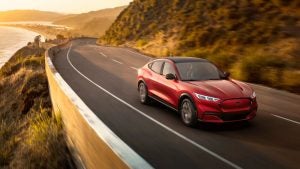 Red 2021 Ford Mustang Mach-E Driving on Cliff by Water