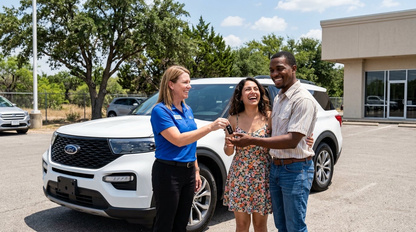 A saleswoman in a blue polo hands car keys to a laughing couple in front of a white Ford SUV at a dealership. (Representative image for illustration purposes only. Actual vehicle may vary based on trim and configuration.)