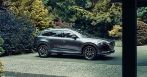 A silver 2020 Mazda CX-9 parked in the driveway of a home in Wichita, KS