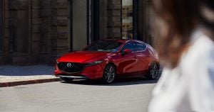 A red 2019 Mazda3 Hatchback parked on the street in Wichita, KS