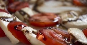 Tomato slices and mozzarella with balsamic drizzle available at Bella Vita Bistro in Wichita, KS