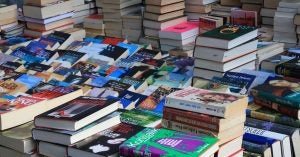 A large collection of books for sale on a table at a local bookstore in Wichita, KS