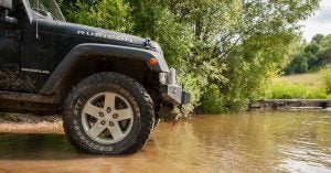 A Jeep Wrangler driving through a creek near Wichita, KS