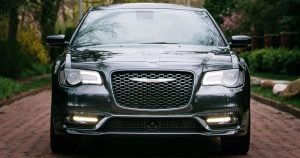 A front view of the 2019 Chrysler 300 in dark gray driving in Wichita, KS.
