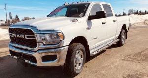 A RAM 2500 in white parked on a construction site in Wichita, KS