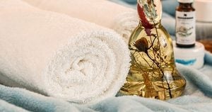 A towel and massage oils resting on a massage table in Wichita, KS