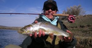 An angler showing off the fish she caught