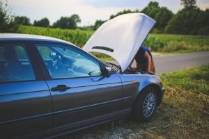 Person Trying to Fix Broken Car